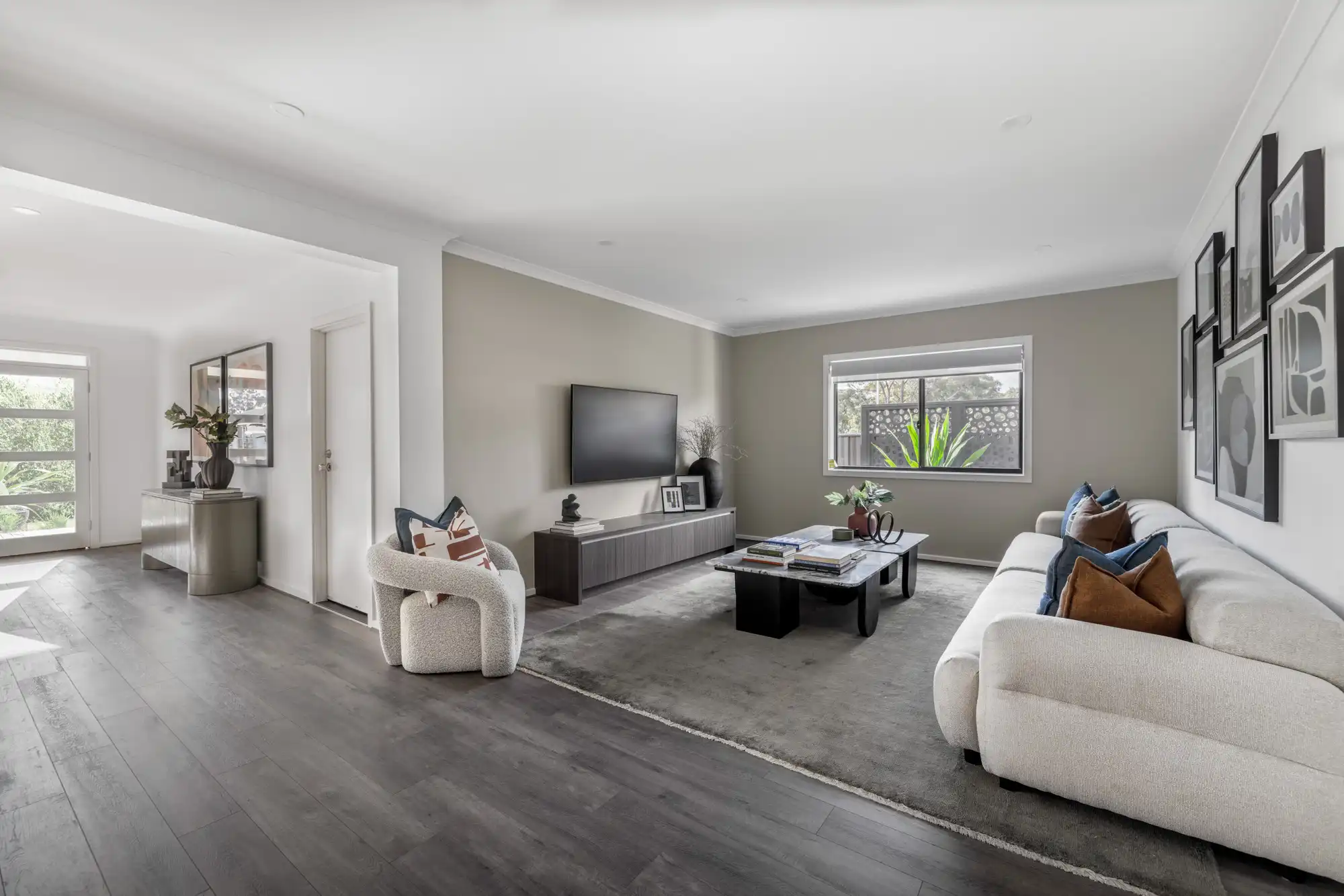 open plan concept with second living space. Feature walls and dark timber flooring throughout the home, at the Hardy 26.
