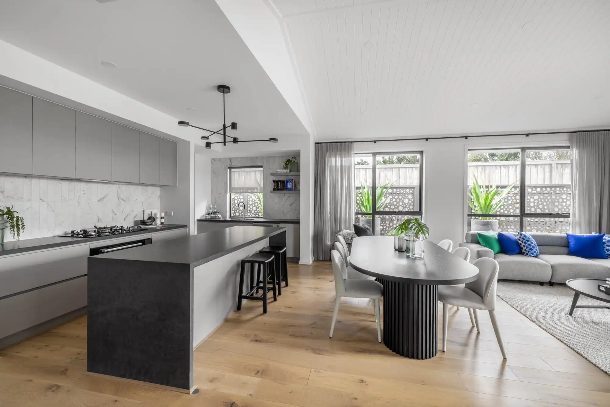 Berrima 28 in Warragul with timber flooring marble splashback and wood cladding ceilings in the dining and living room area