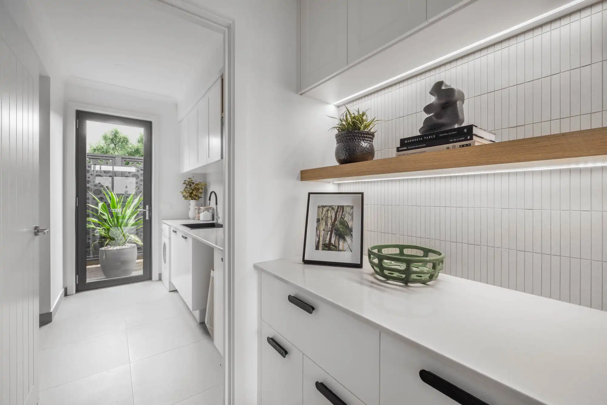 Coastal hamptons style laundry at the Redhill 30 with white and timber finishings