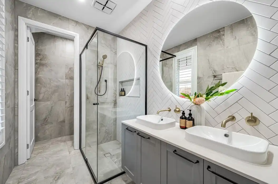 luxe bathroom features with herringbone tiling and brass tapware at ascot 28