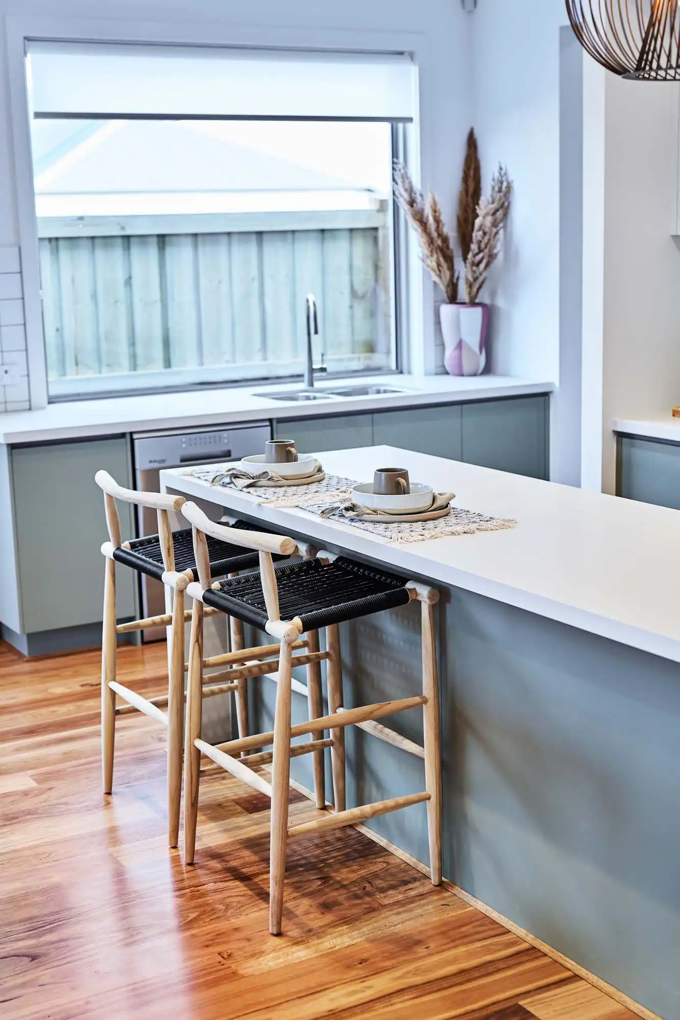 Blackbutt timber flooring a bold contrast of light and dark tones is balanced by the warm wood accents and white countertop at the berrima 28
