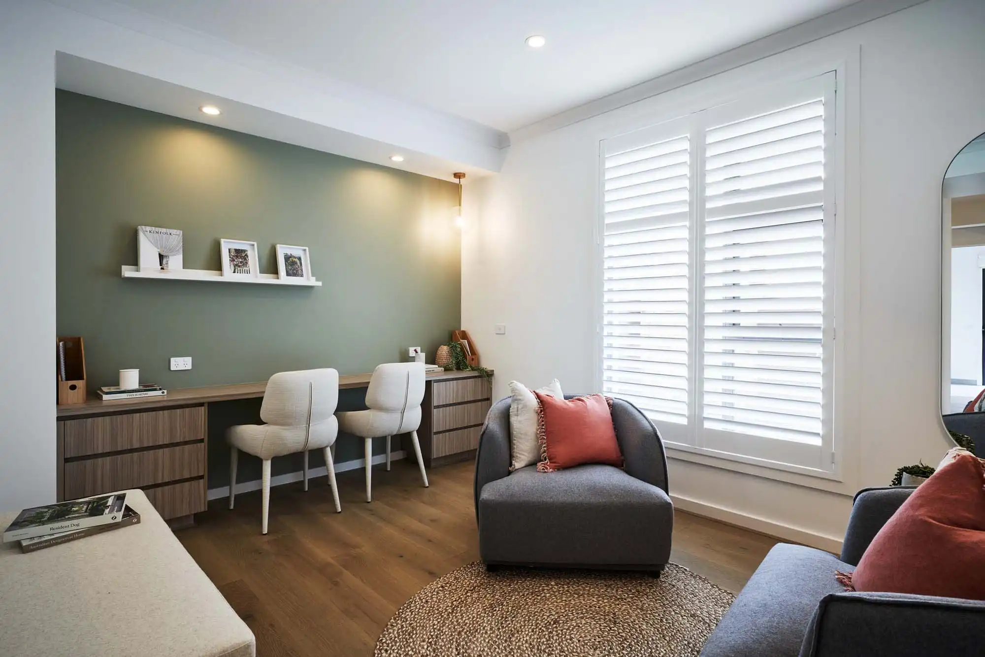 sage coloured wall with timber draws and benchtop balanced between an open study and living space at castlemaine 41