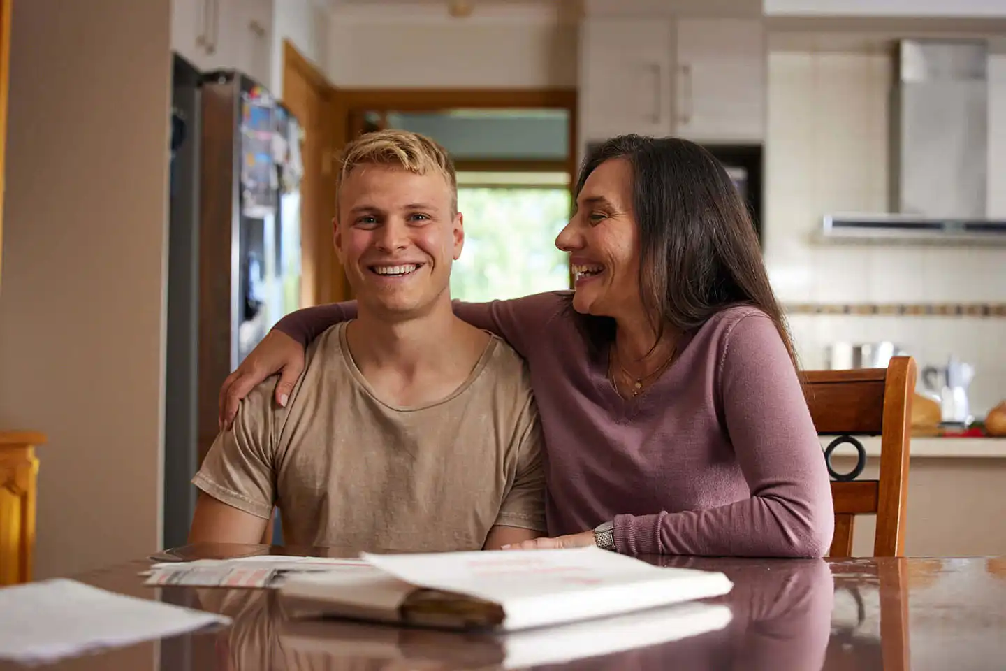 A photograph of Connie and Kyle inside the house seated at the dining room.