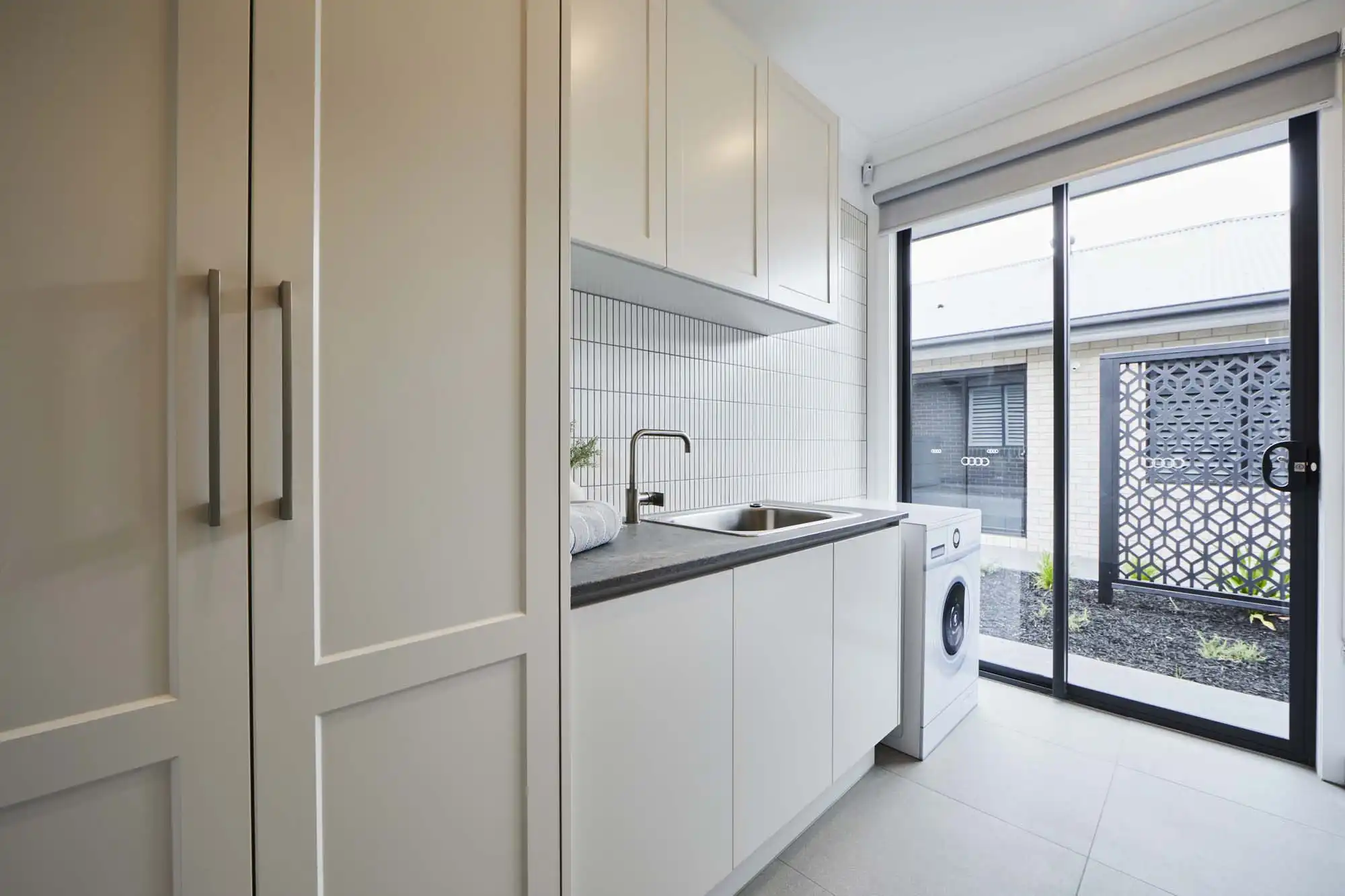 neutral colours with kit kat vertical stacked tiling in laundry at dromana 28