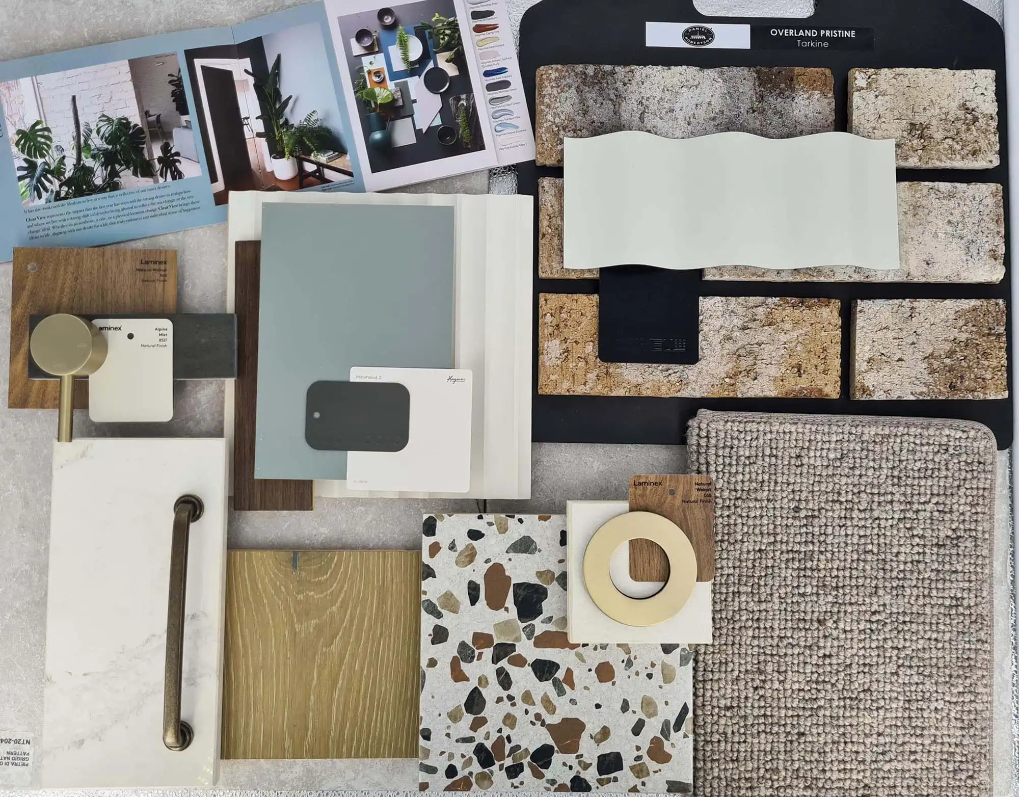 flatlay styles with brass chrome facusets and handles with concrete and carpet