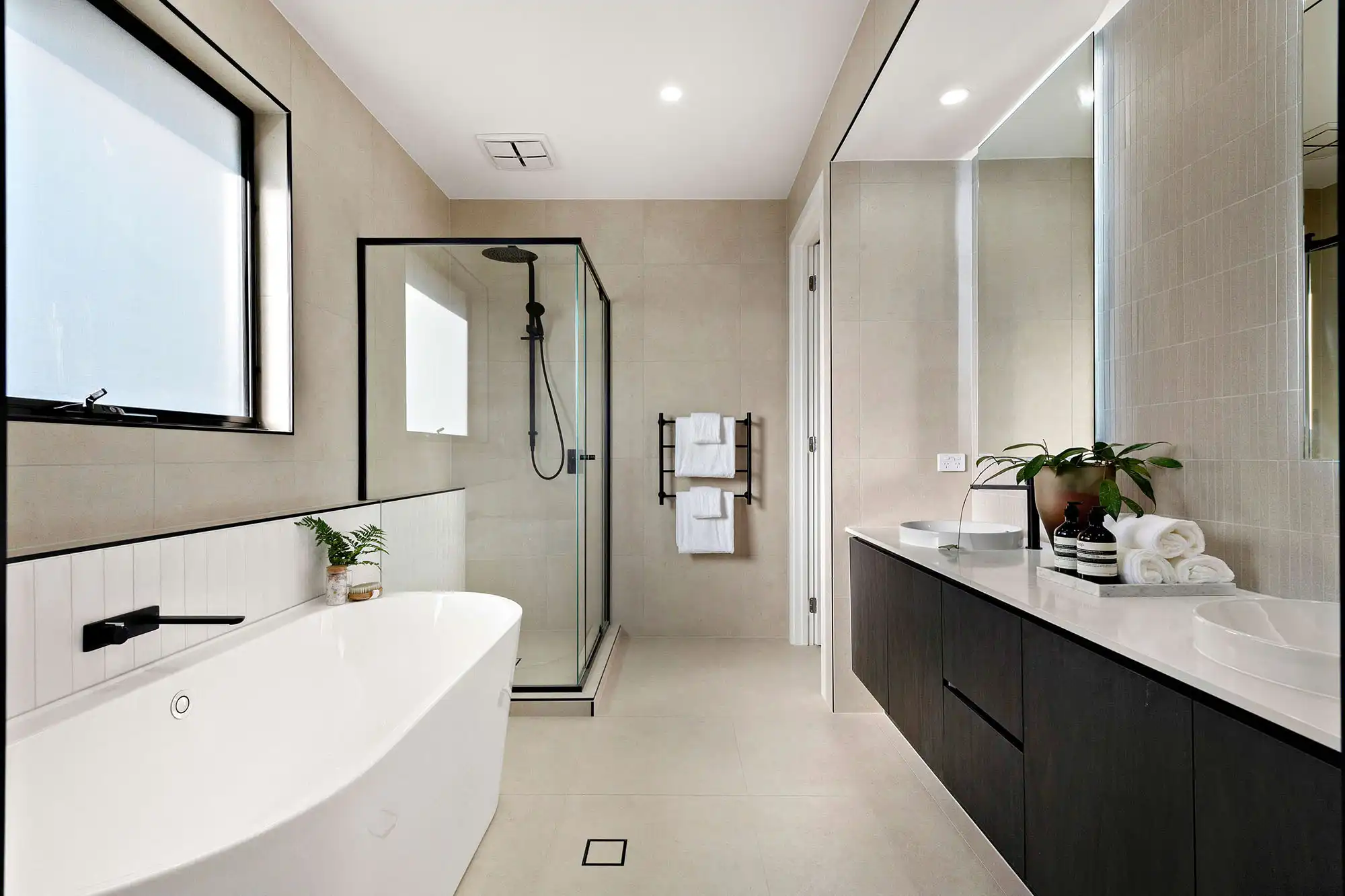 led lighting features behind mirror dark timber cabinetry with matte black finishings
