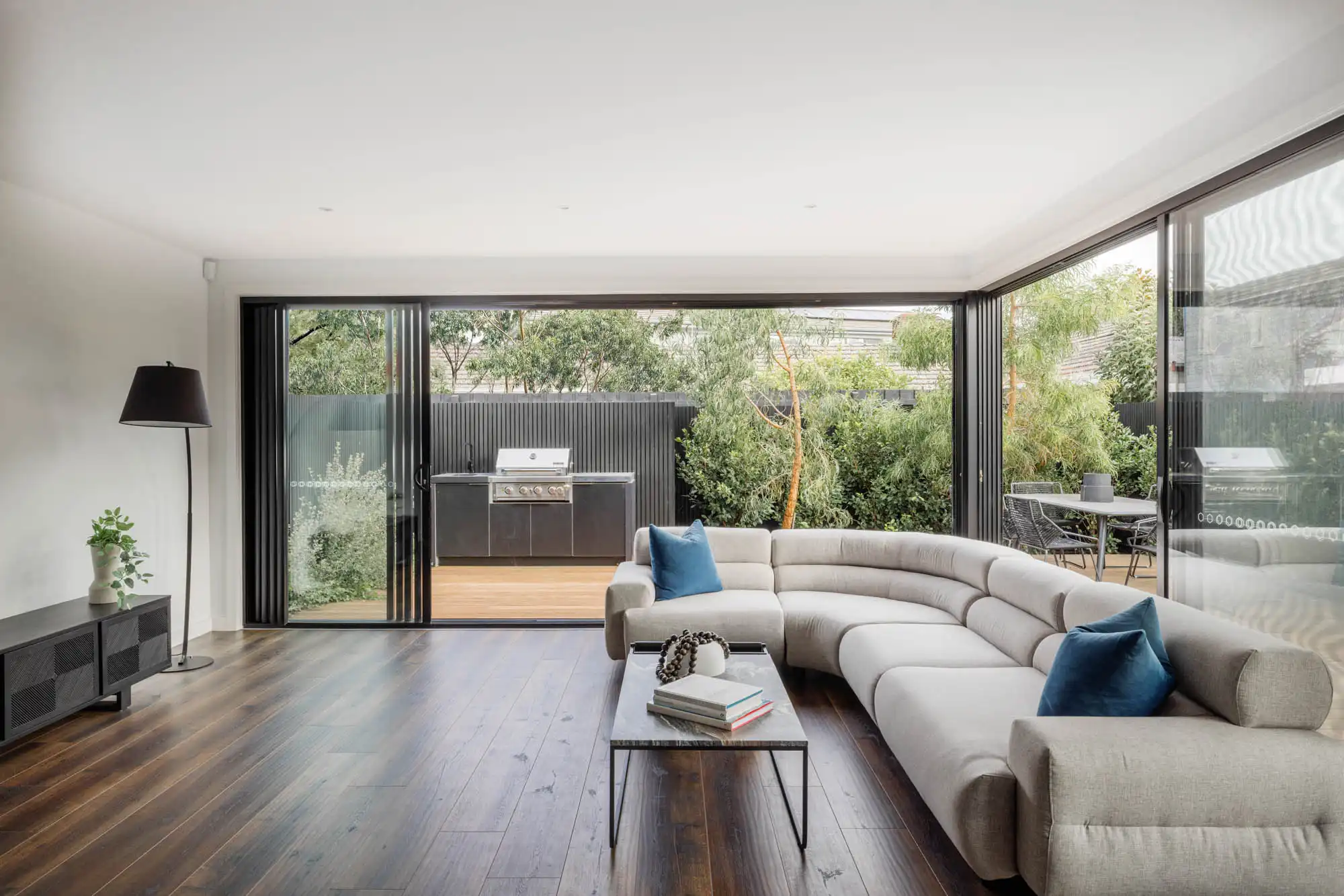 Milford Masterpiece home with dark timber flooring connecting through to the alfresco