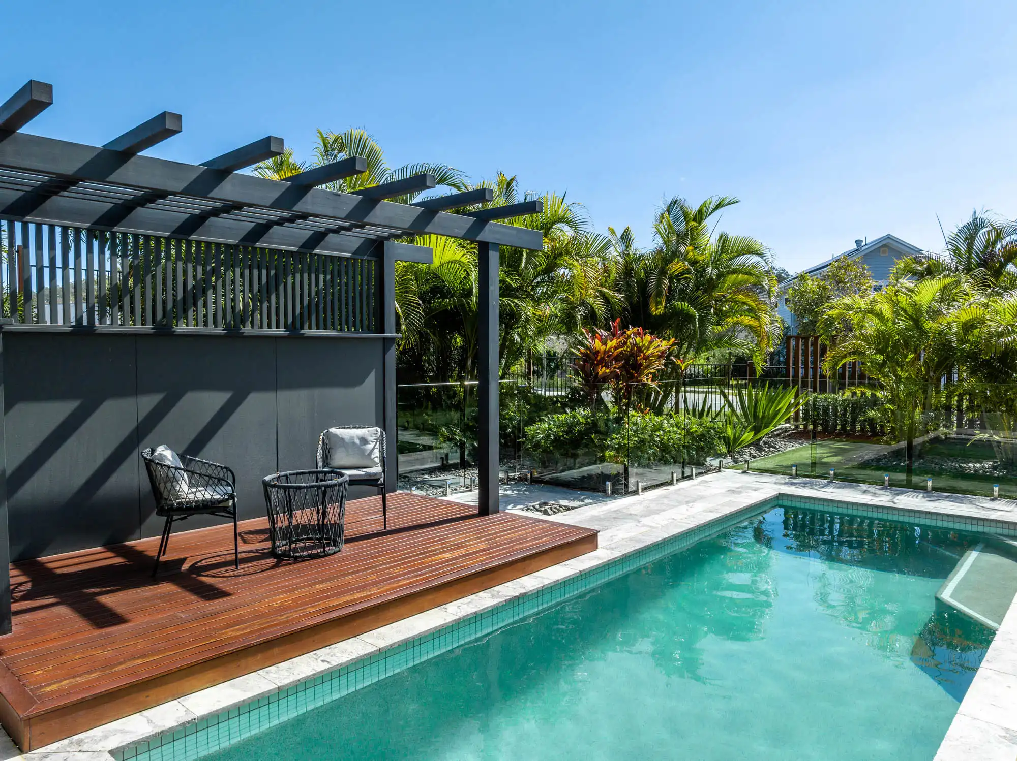 building a new home with stone tiling surrounding the pool with a pergola at the Queensland colston 26