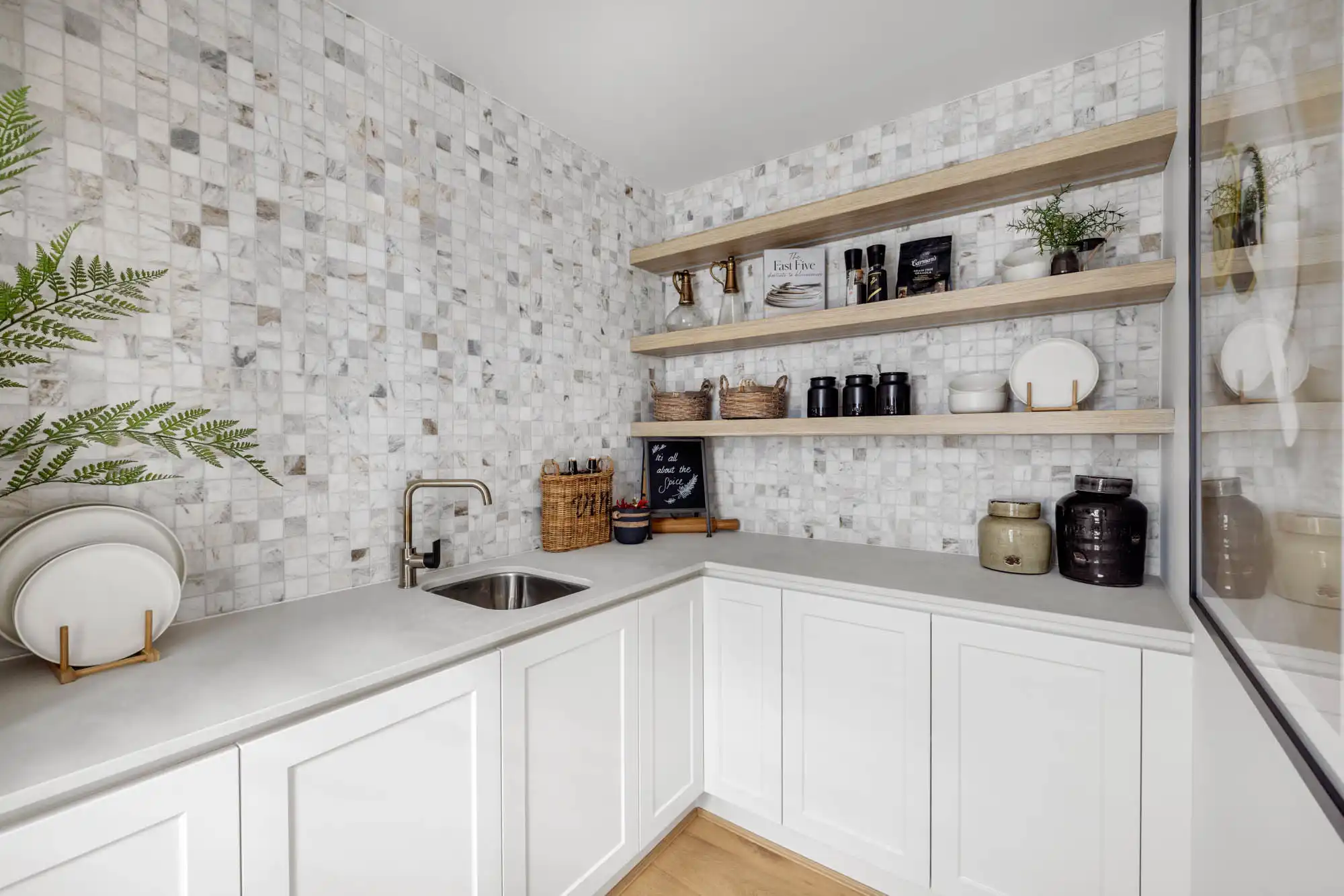 coastal themed butler's pantry with stoned tiling and timber shelving at riverway 26 whiterock