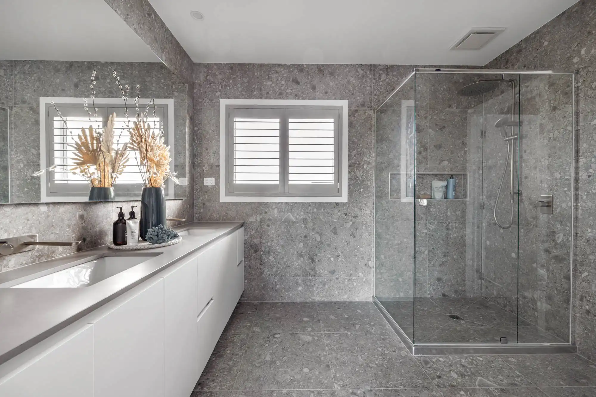 polished concrete tiling in the bathroom with chrome facuets features at the tavertine 31