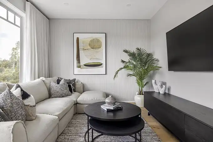 coastal living space with wood cladding and floor to ceiling curtains at riverway 26