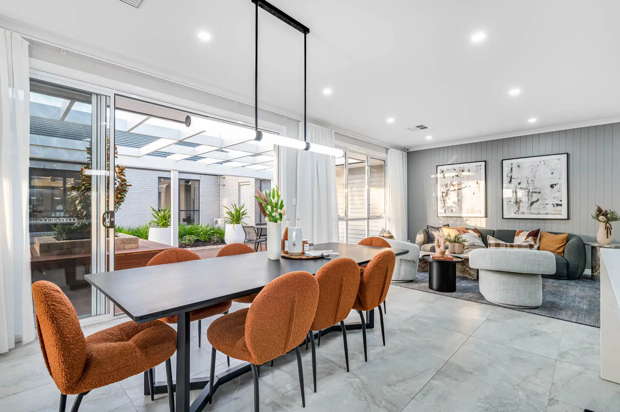 wood cladding and marble tiles with sliding doors opening into the alfresco at this ascot 28