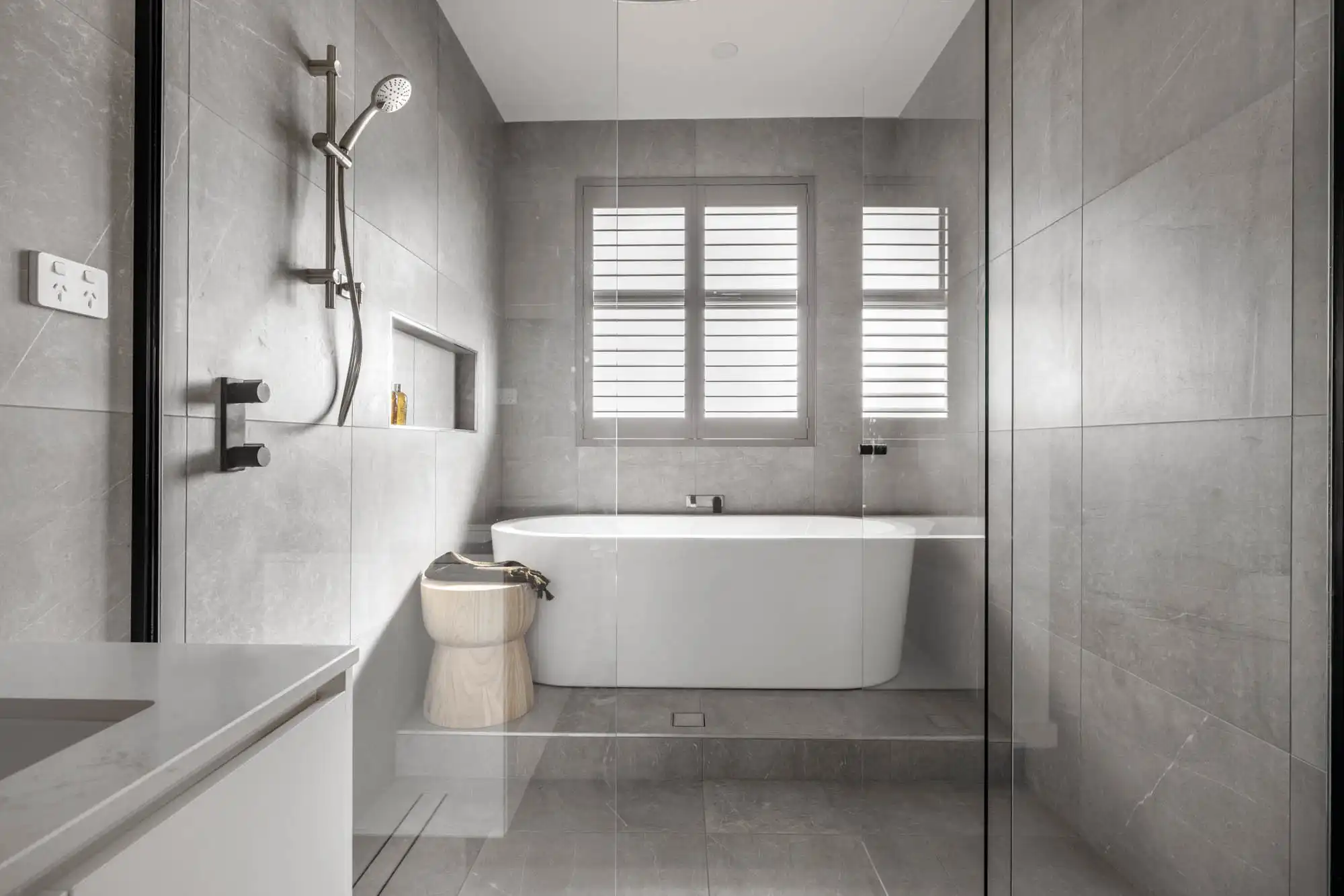 elevated freestanding bath with marble tiling and shutter blinds at the hampstead 32