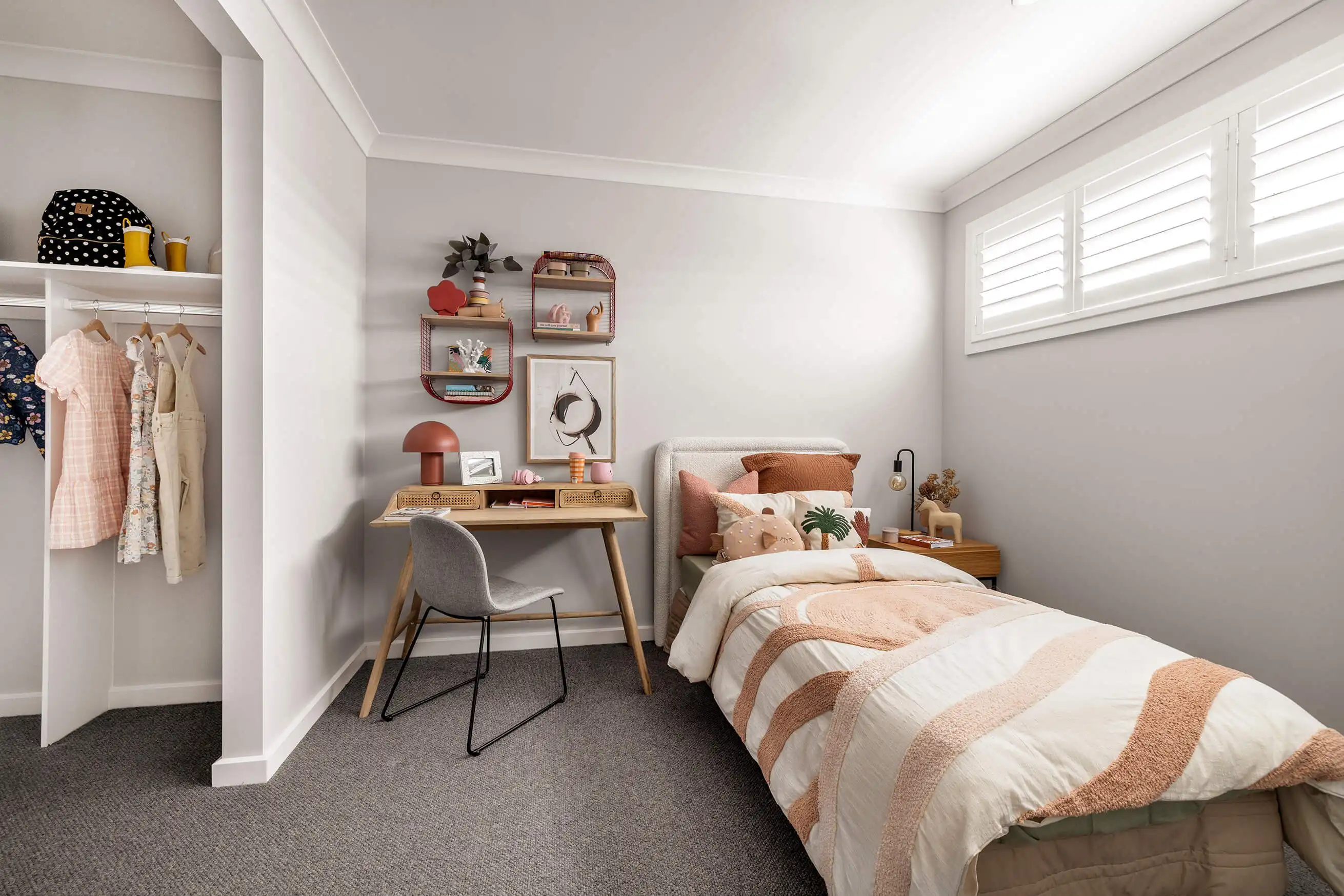 Children's bedroom with a walk in robe that has neutral walls to use rich vibrant interiors