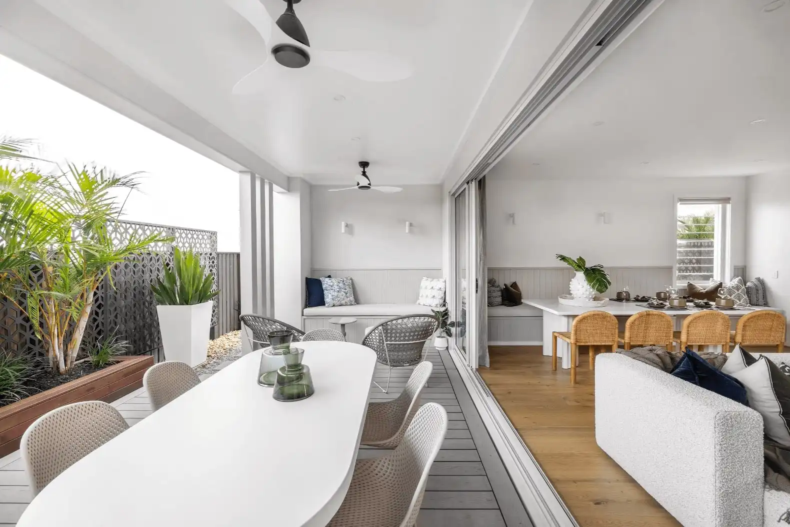 undercover alfresco connecting to indoor living space with open sliding door feature and day bed