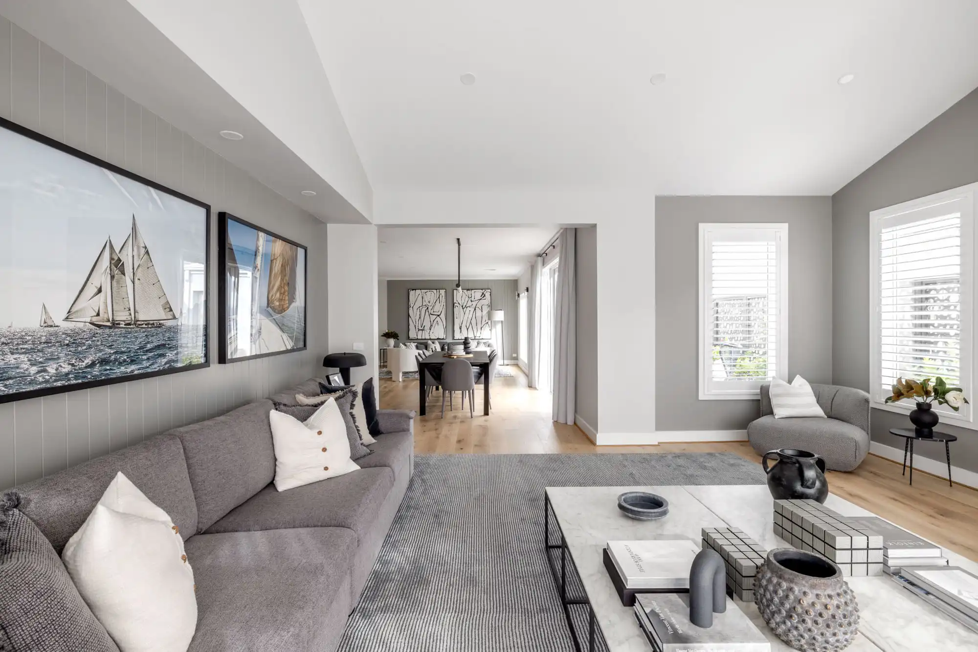 a single storey design with multiple living areas and grey coloured feature walls that flow throughout the akuna 29