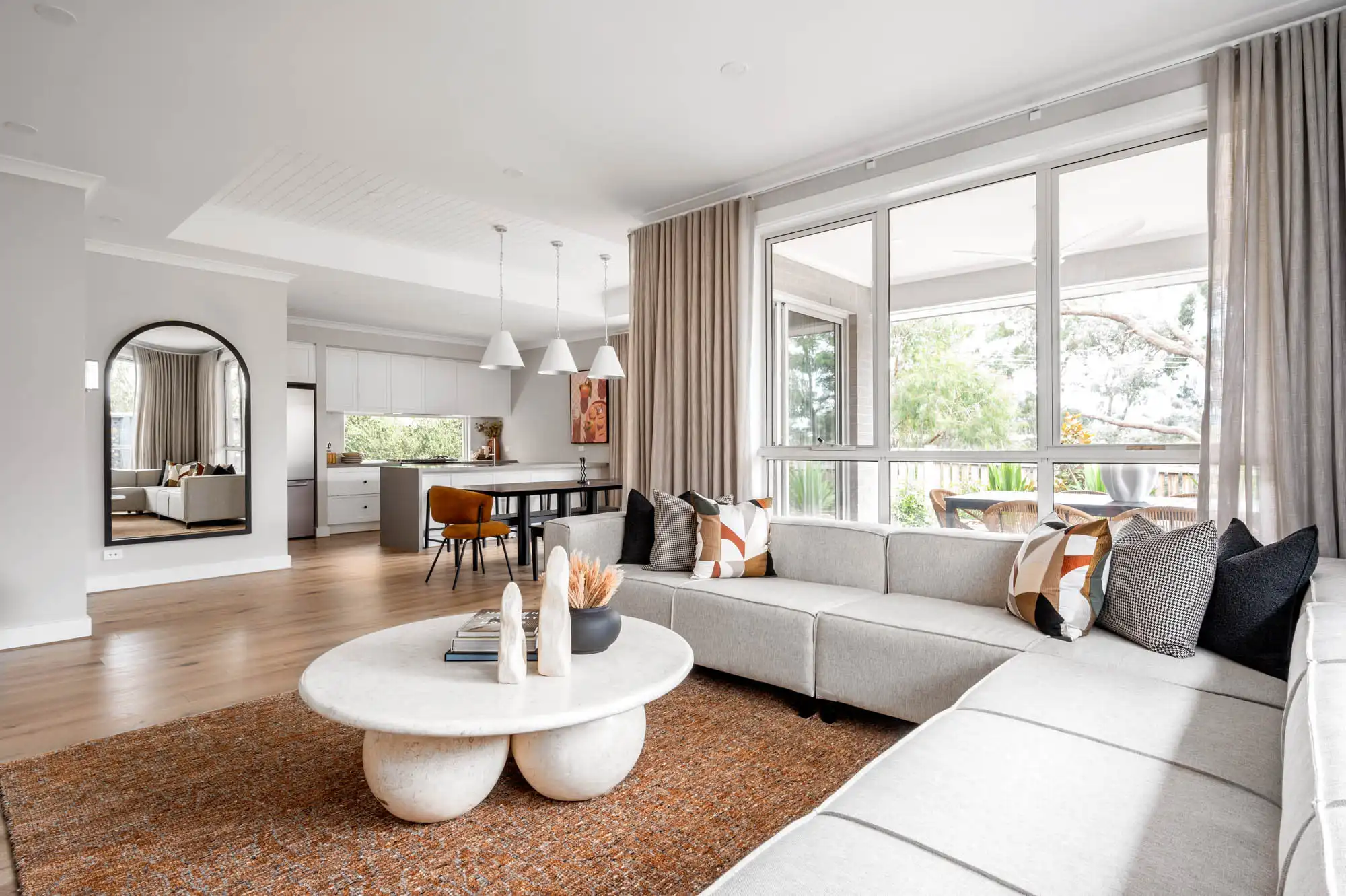 open living and dining area with natural lighting and raised ceiling at nowra 26