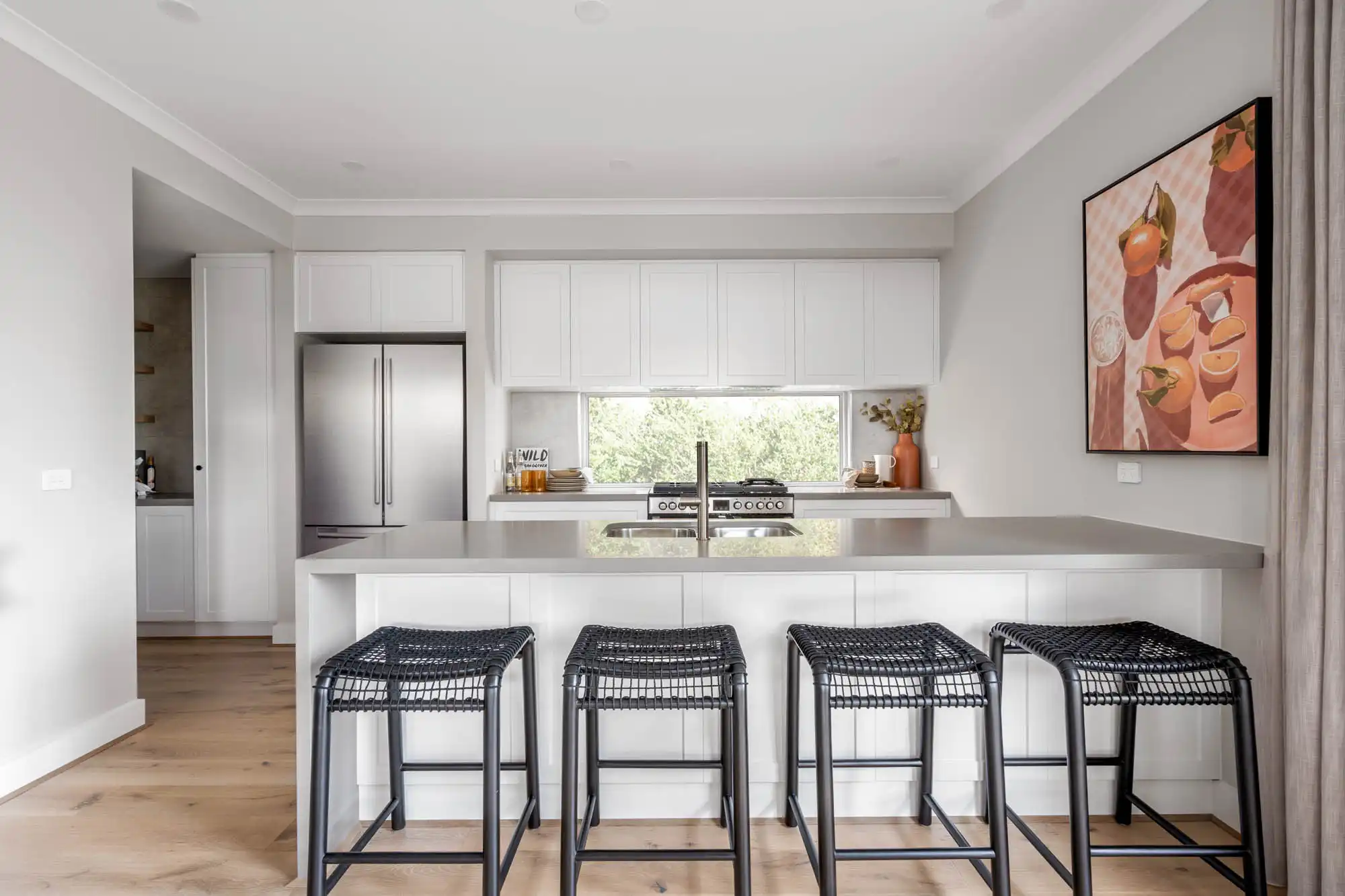 white crip modern kitchen and a bold statement artwork with vibrant colours at nowra 26