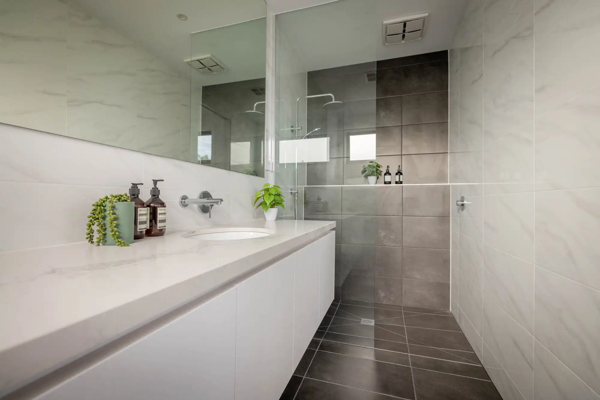 Interior photo of a open plan bathroom and tiled walls and floor as a part of Masterpiece Milford.