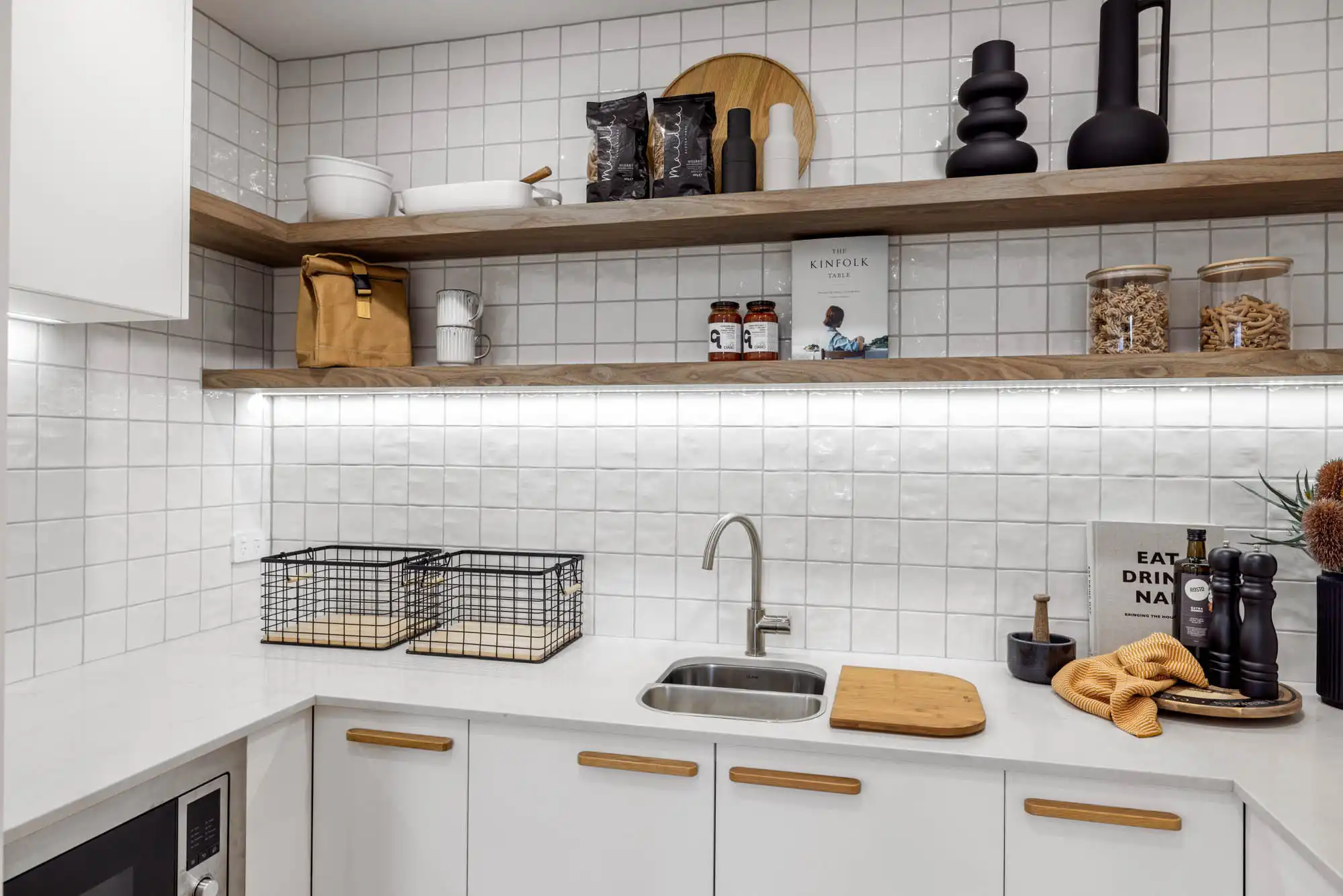 white square stacked tiling in walk in pantry with wooden features to balance the space up