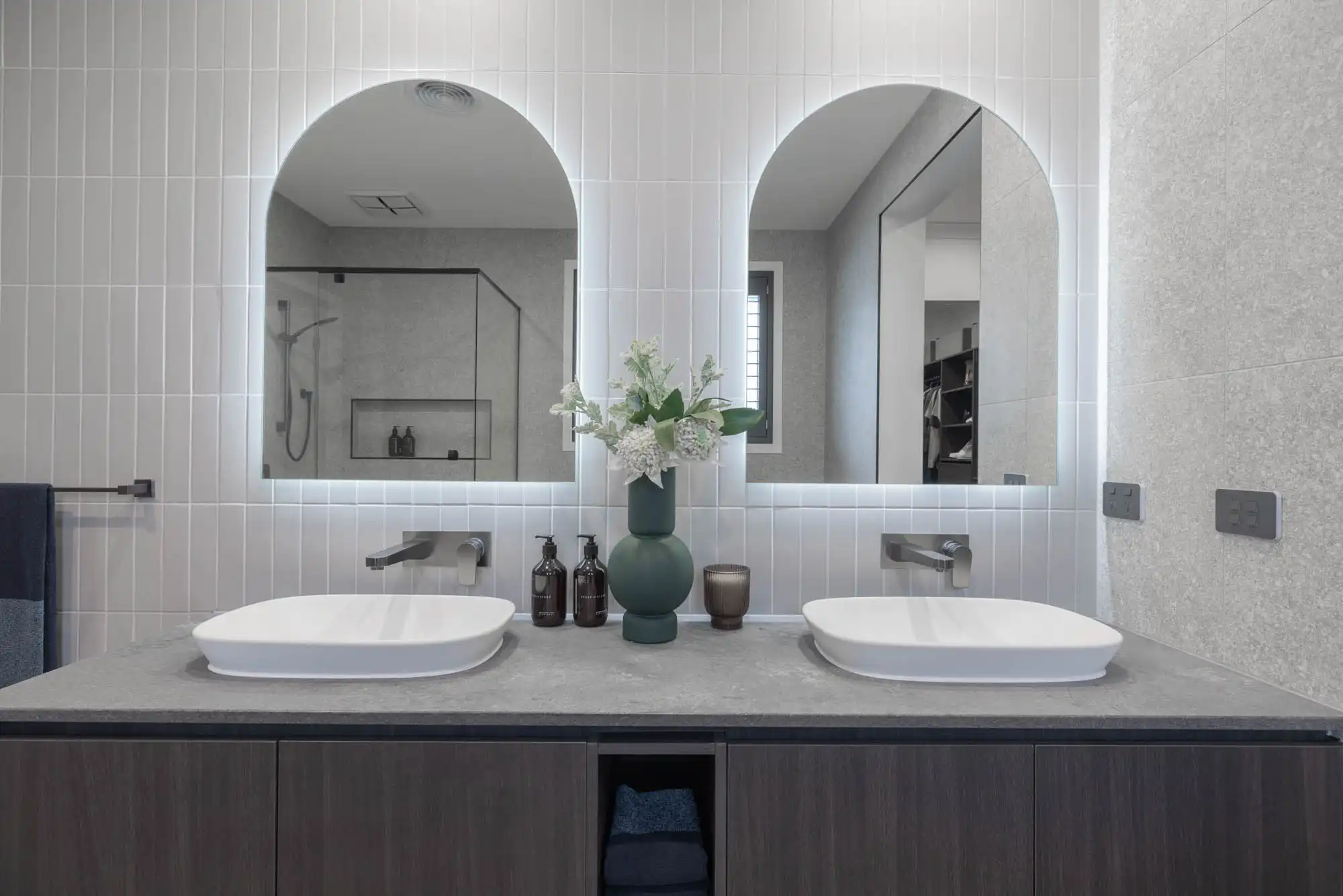 light grey vertical subway tiles stacked with dual mirrors and sink in bathroom at silverton 45