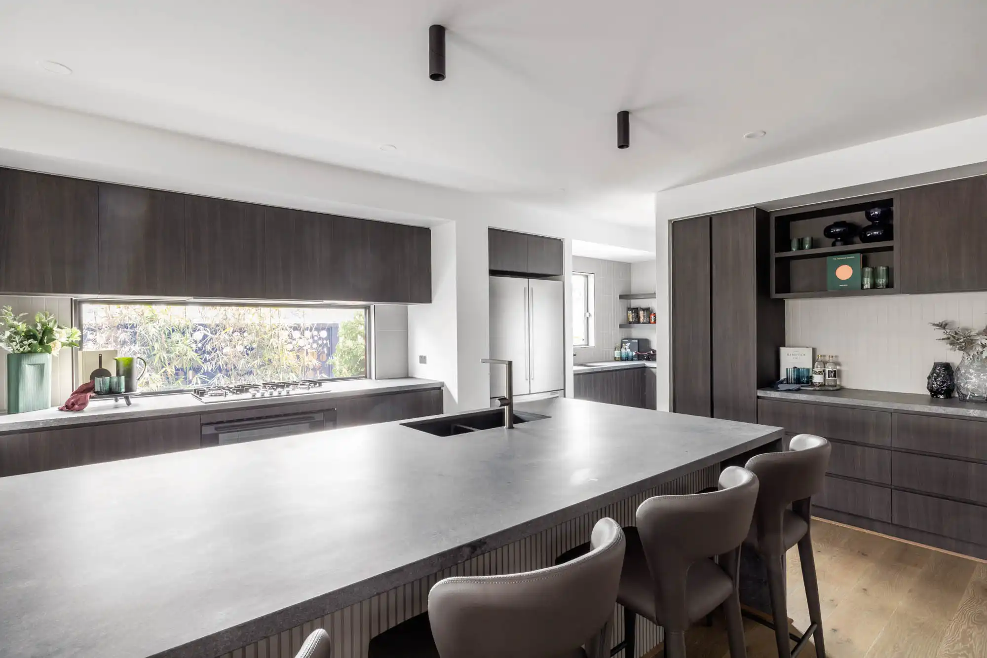 modern contemporary kitchen and benchtop with dark timber interiors