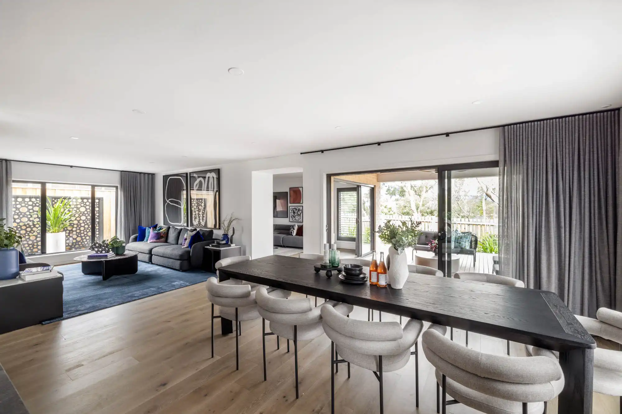 modern contemporary home living and dining space with wood features adding texture to this silverton 45 home