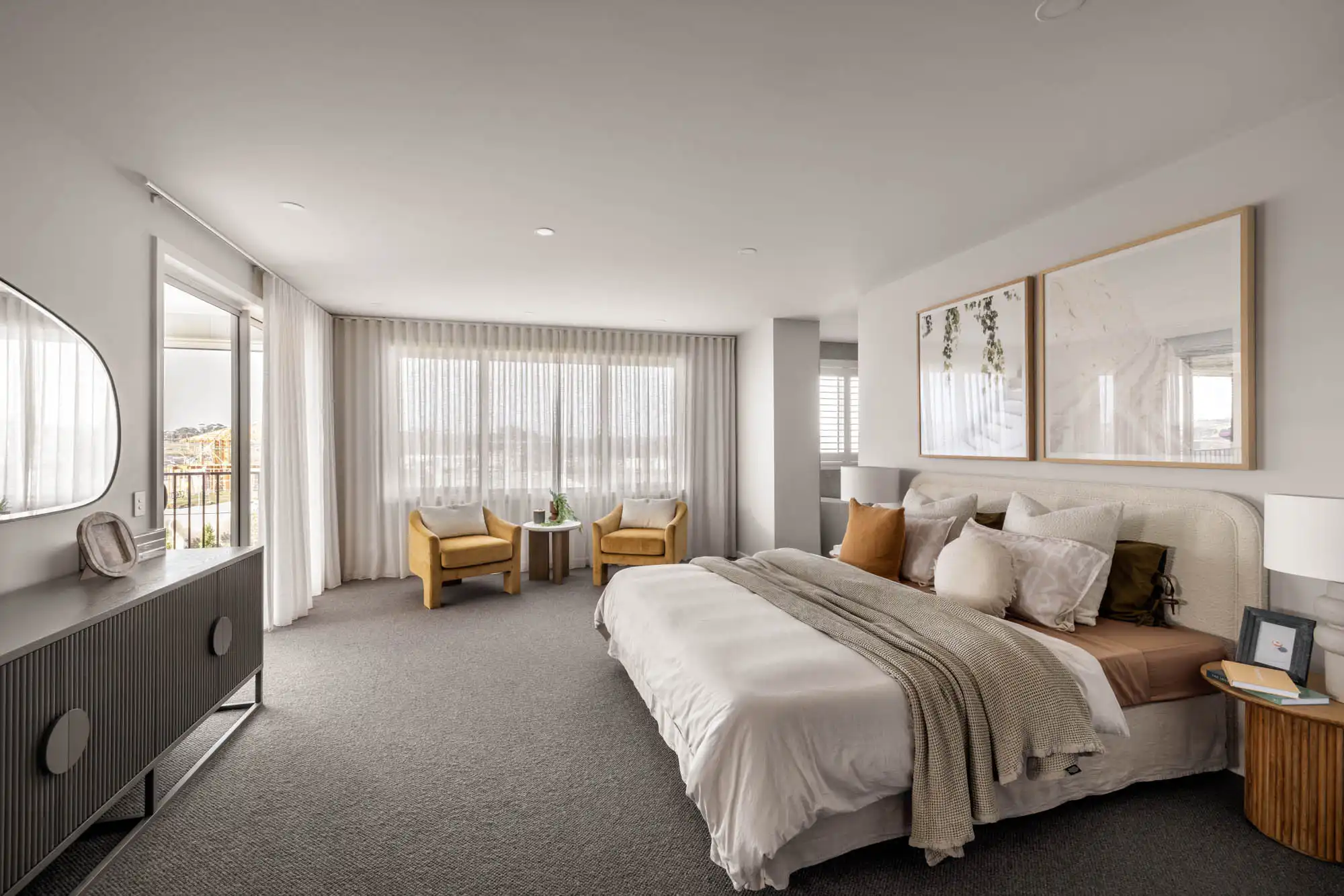 contemporary coastal master bedroom leading to a private balcony with sheer floor to ceiling curtains at tallowood 52