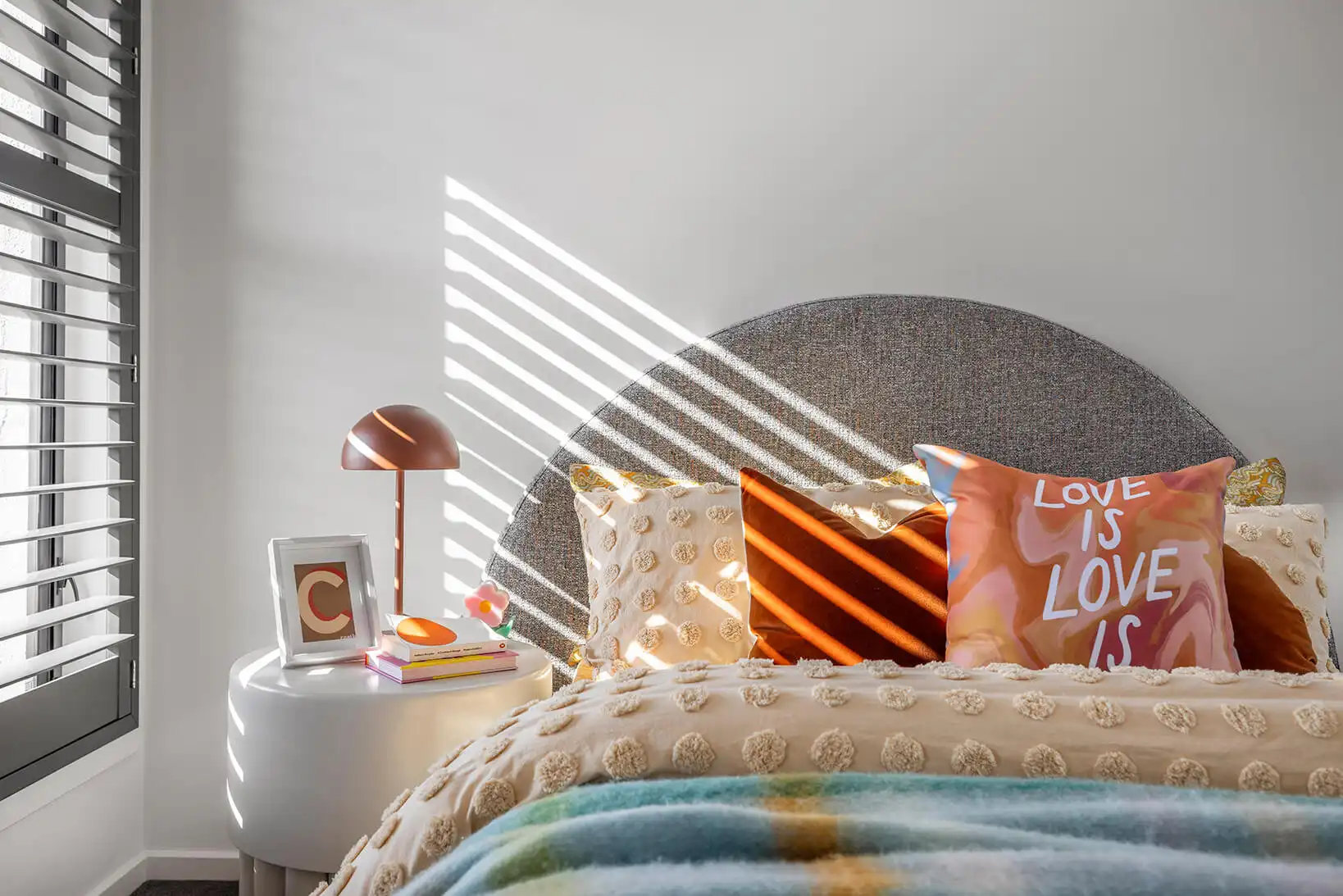natural lighting through the plantation shutters and vibrant textured interiors for a perfect kids bedroom