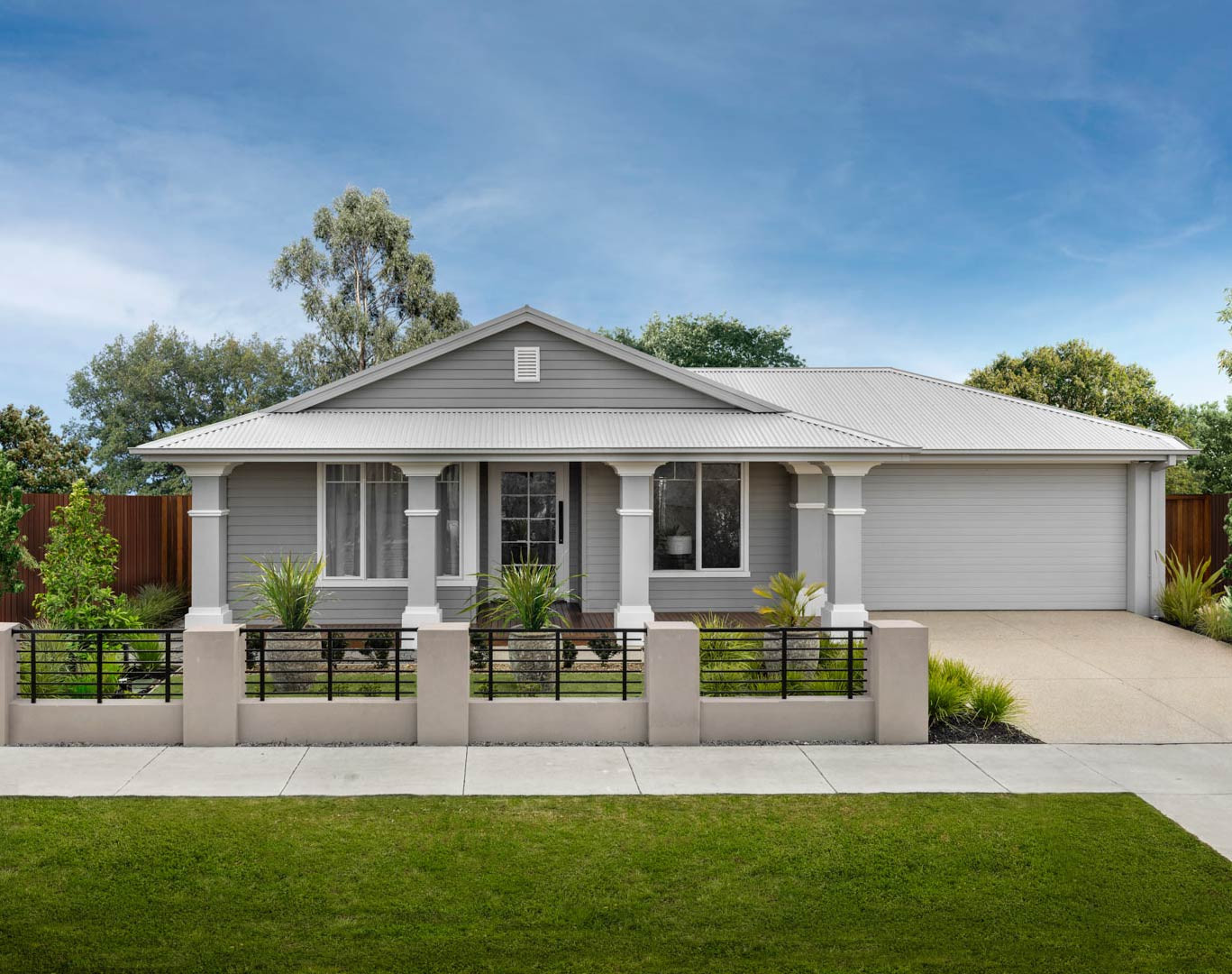 An exterior image of a single storey home with a garage space and a front yard as a part of Akuna 29 facade.
