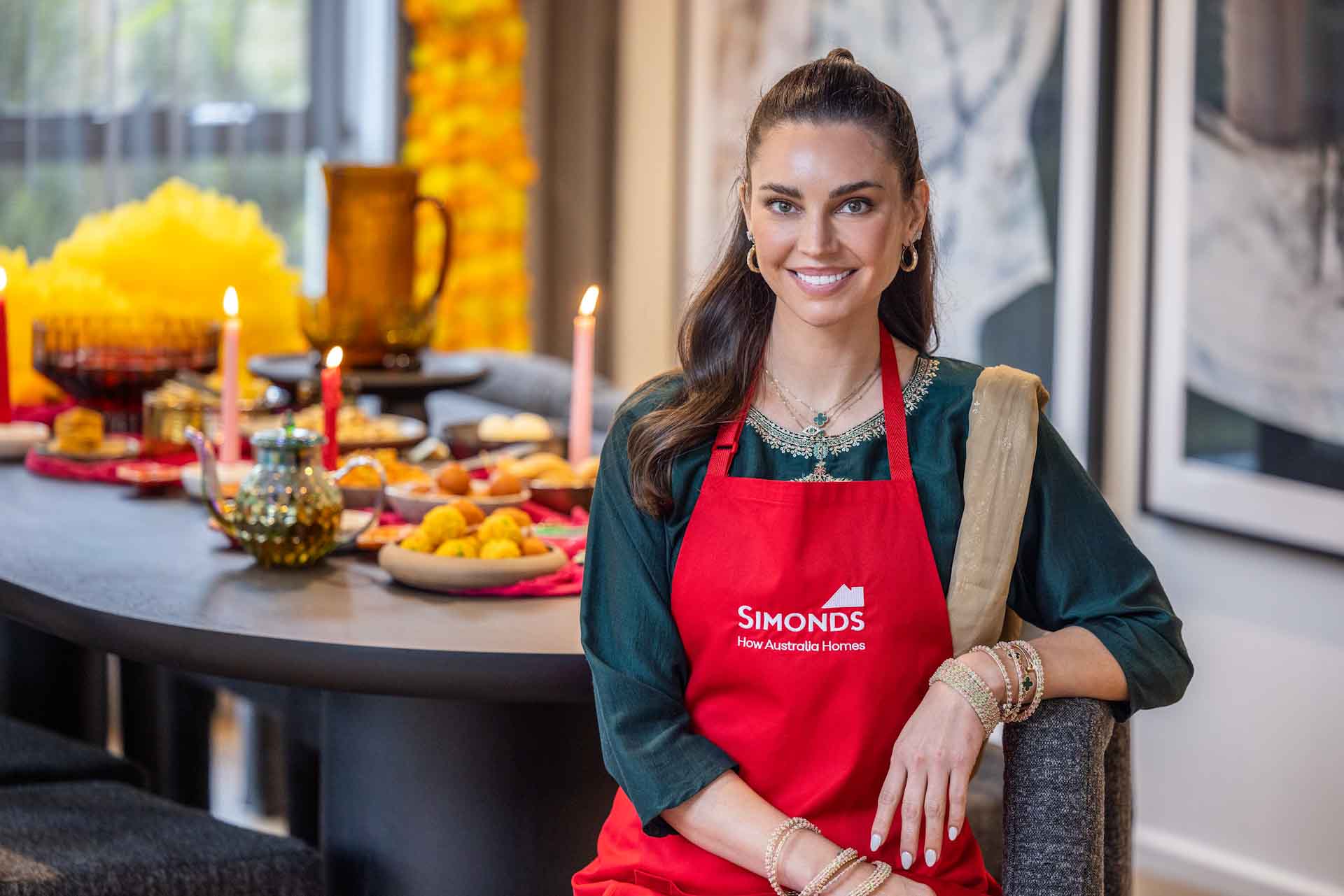 Simonds brand ambassador Sarah Todd sitting at in front of a table set for Diwali.