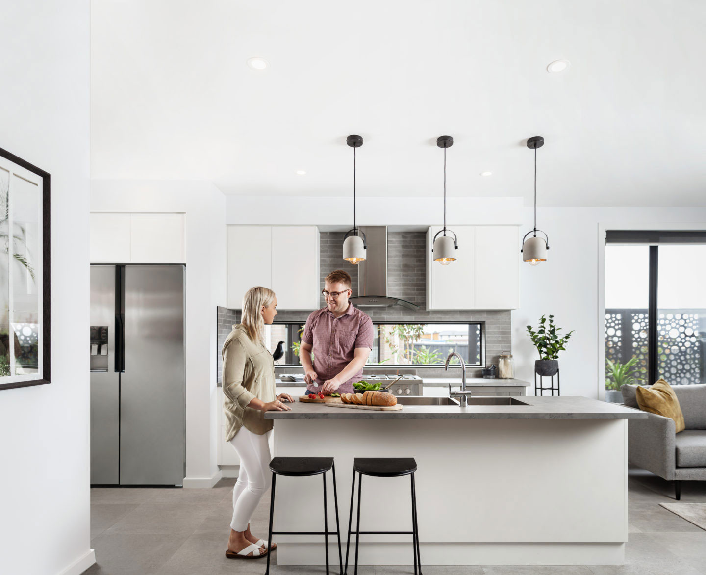 subway tiles as splash back in kitchen with 3 lighting features installed on top of island bench