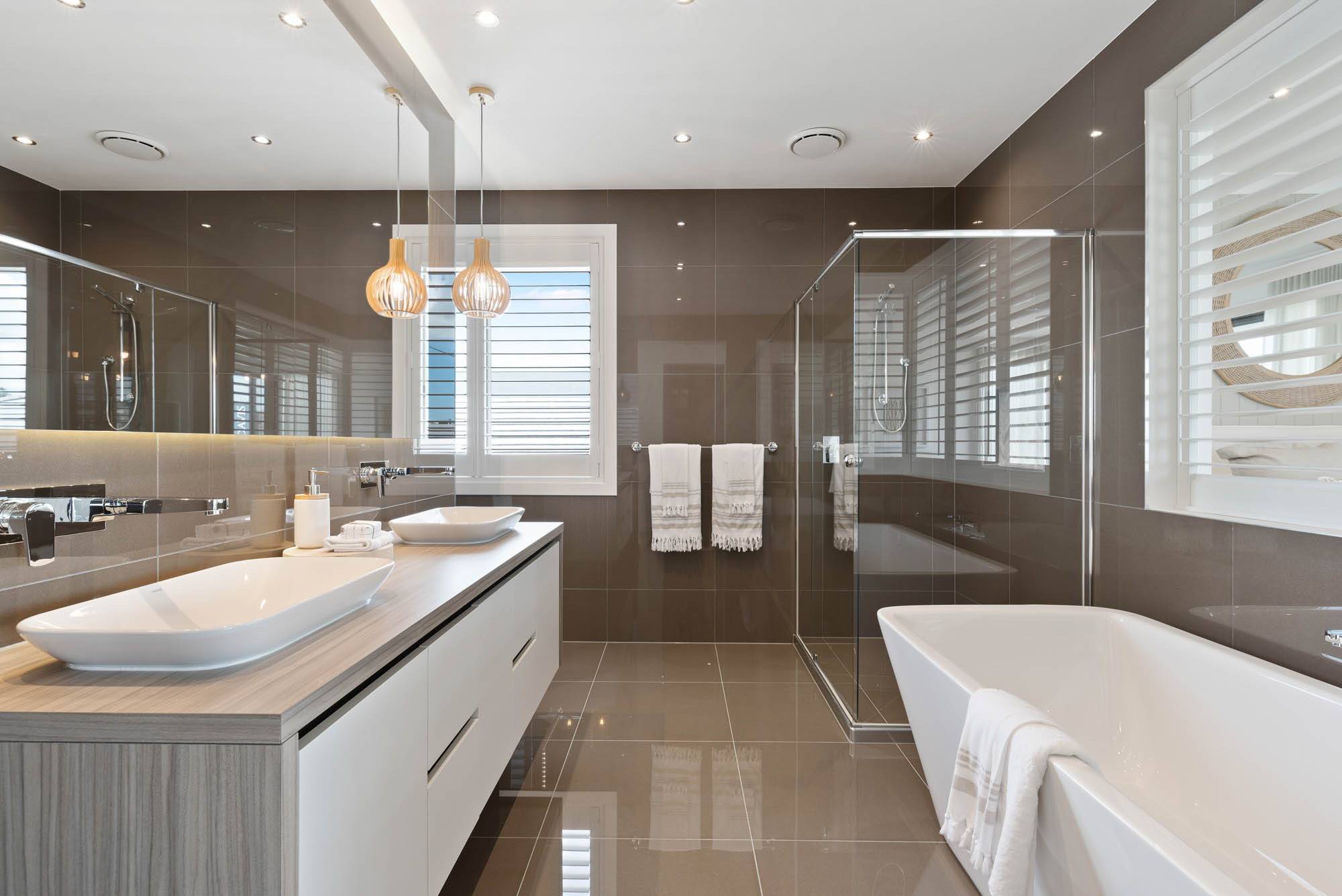 An interior image of a bathroom with a double sink vanity and glass shower cubicle as part of Simonds Starboard 33 home design.