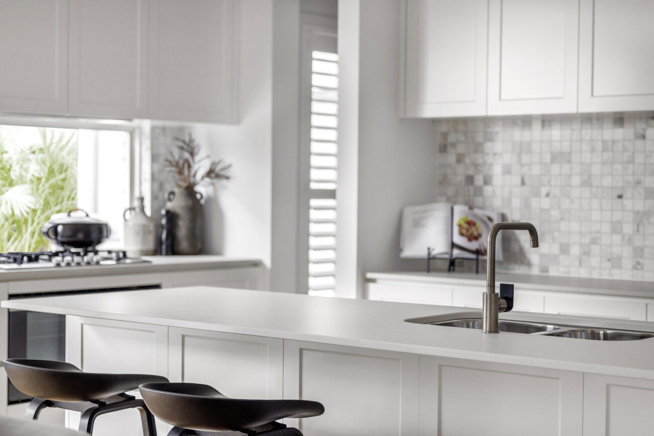 white crisp modern kitchen with chrome faucet interior at the riveway 26