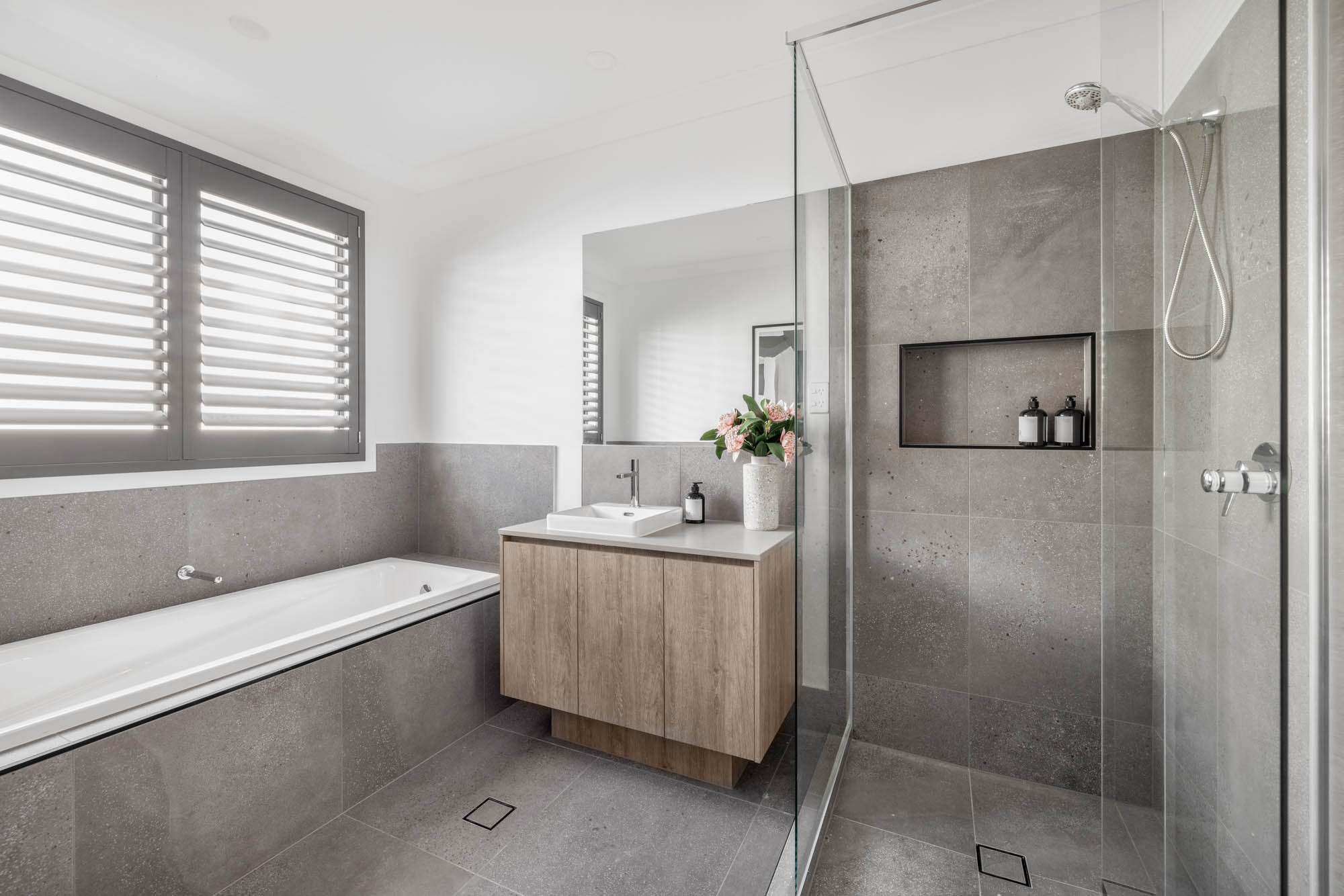 An interior image of a bathroom with a glass shower cubicle and a bath tub as part of Simonds Berwick 38 home design.