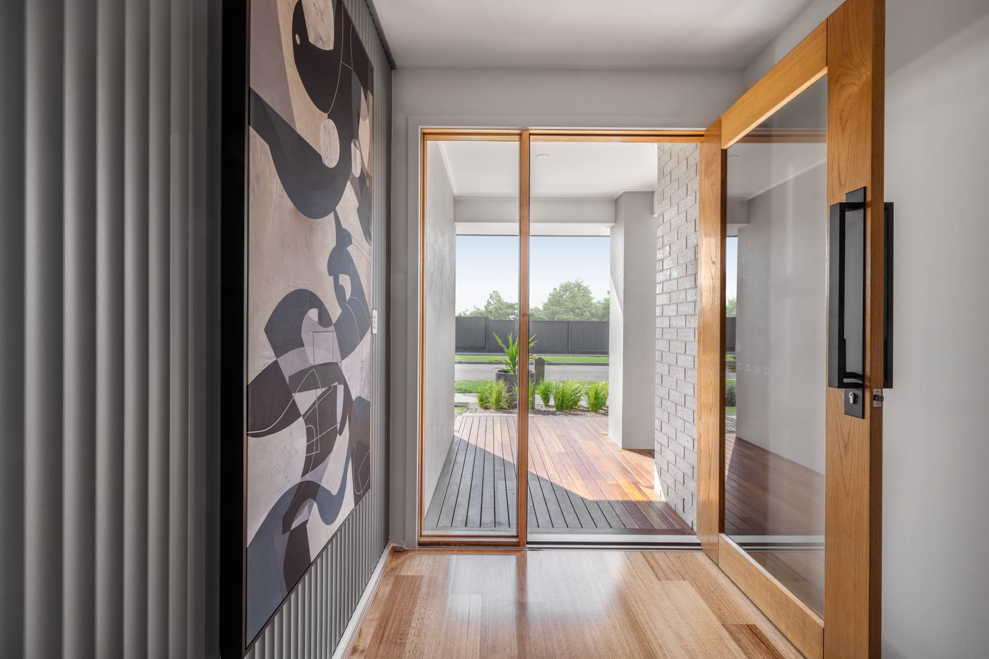 An interior image of a modern contemporary hallway with wooden flooring as part of Simonds Victor 29 home design.