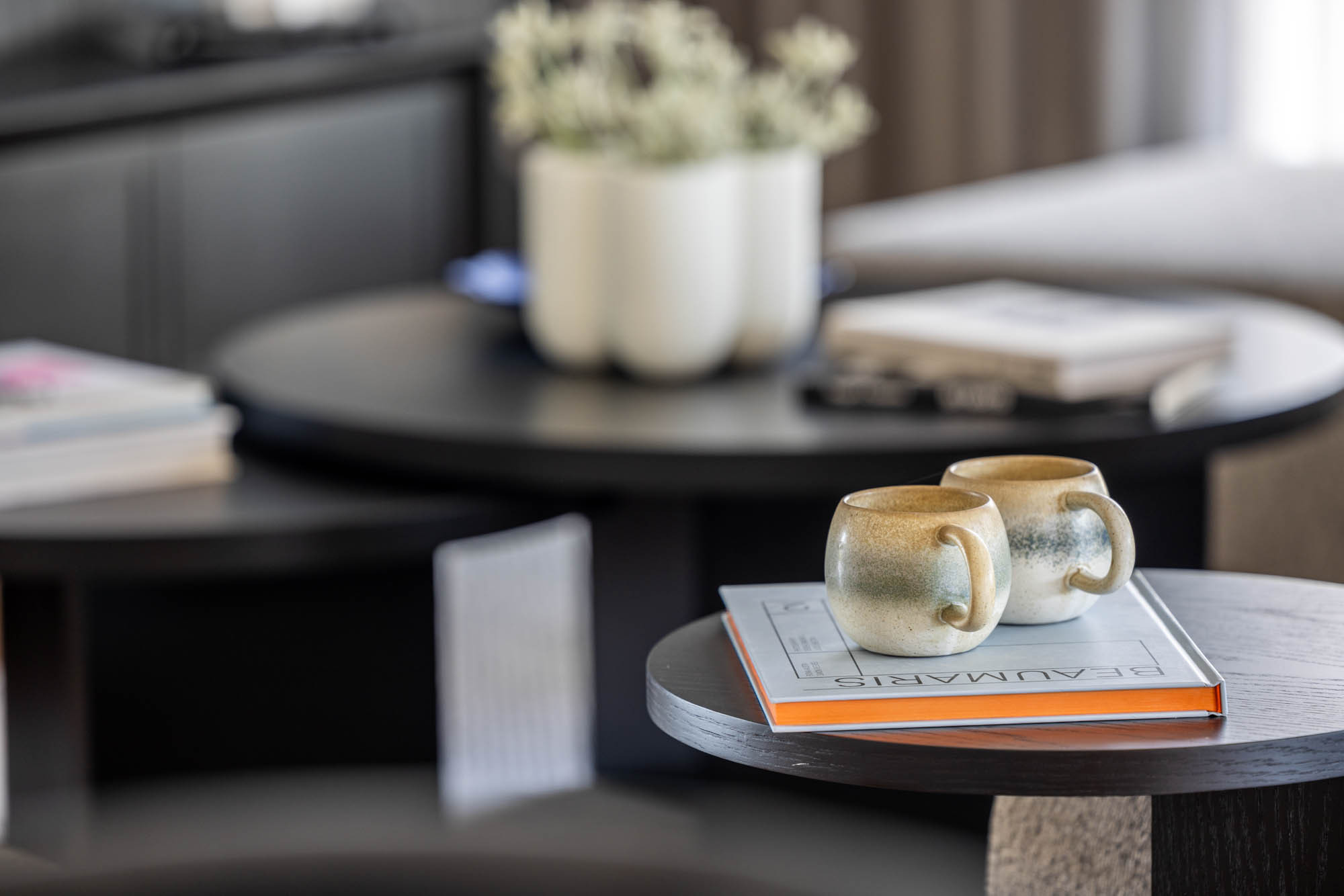 A close-up image of a cosy living area focused on a wooden coffee table as part of Simonds Victor 29 home design.