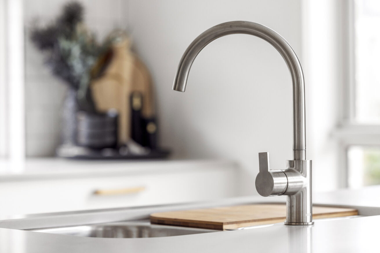 close up detail of chrome faucet with brushed and vibrant shiny finish