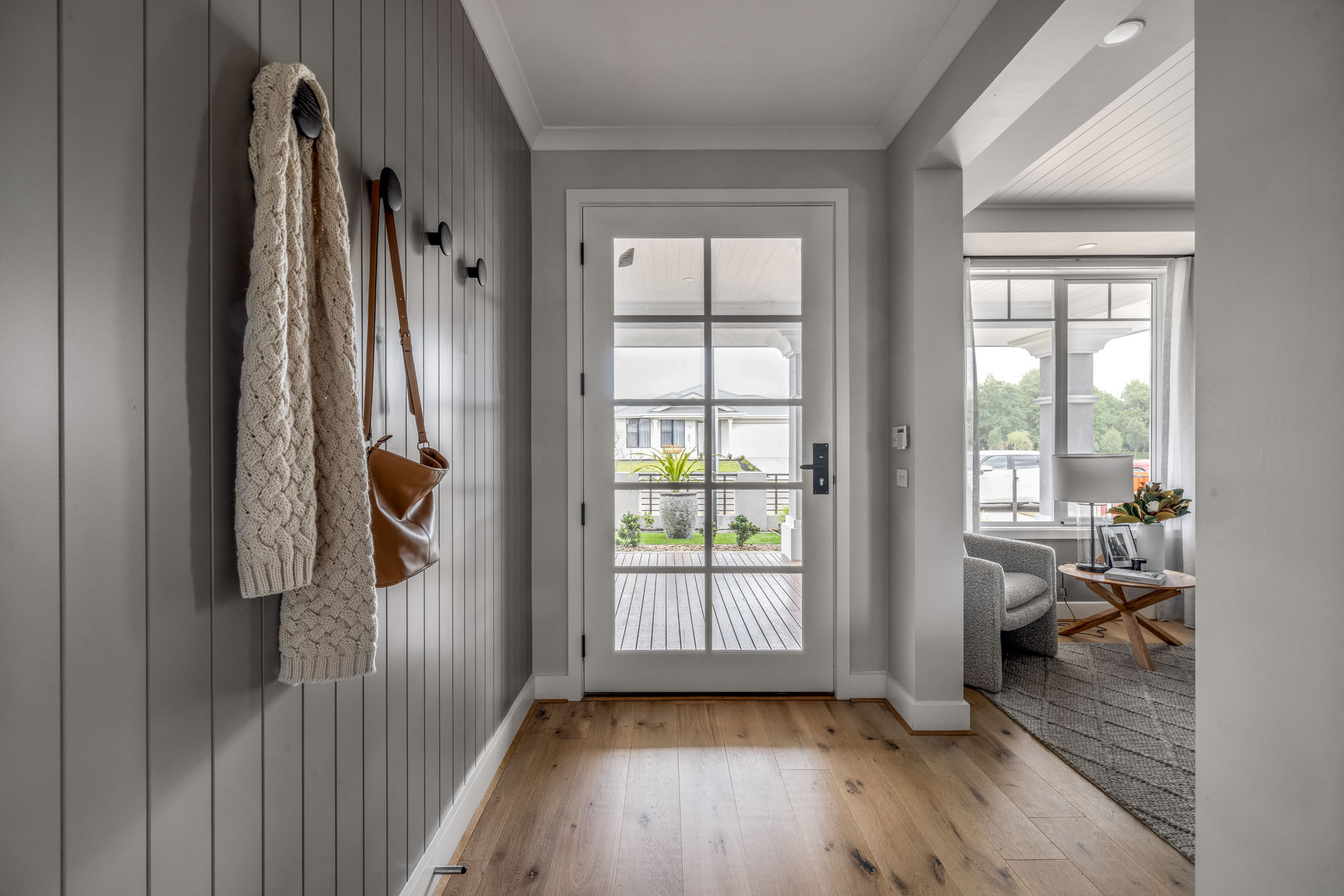 An interior image of a contemporary hallway and living area, wooden flooring as part of Simonds Akuna 29 home design.