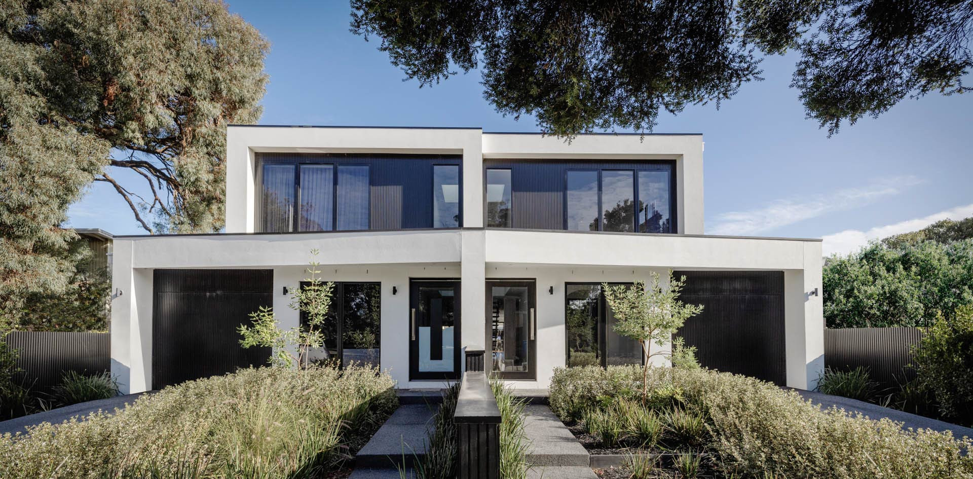 An exterior image of a double storey dual occupancy facade as part of Milford home design.