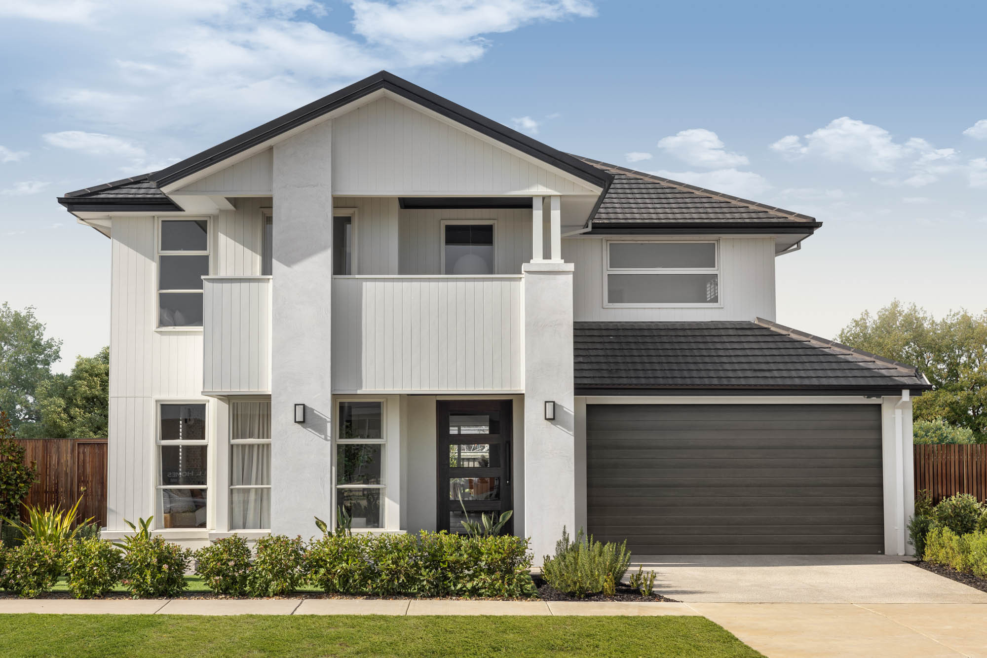 Contemporary coastal-style facade with a 2-car garage at tallowood 52